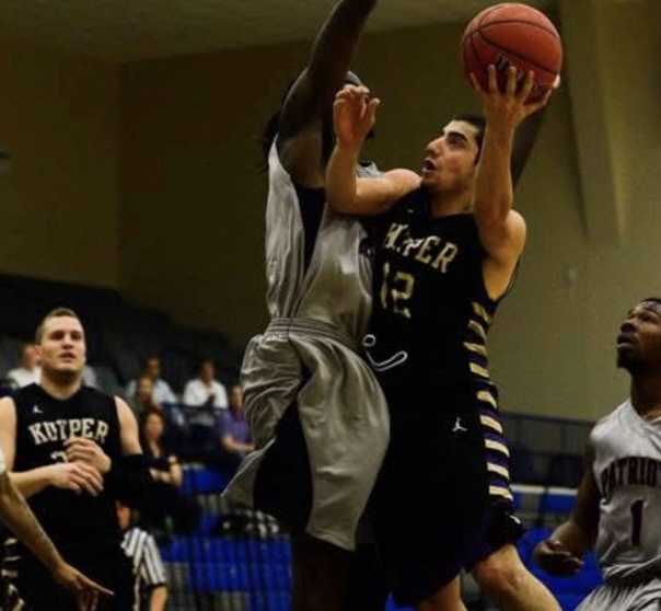 Sal Hermiz driving to the basket in a Kuyper College game